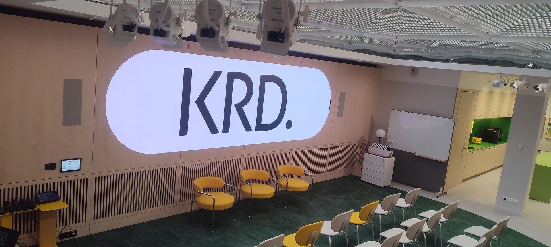 Écran LED intégré au mur d’un espace de conférence d’entreprise, piloté depuis la commande tactile murale.